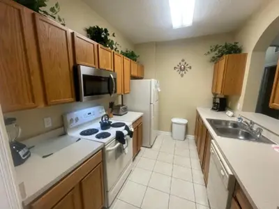 a kitchen with a sink and a stove top oven at Orlando Condo 6428: Your 5-Star Family Getaway in Orlando