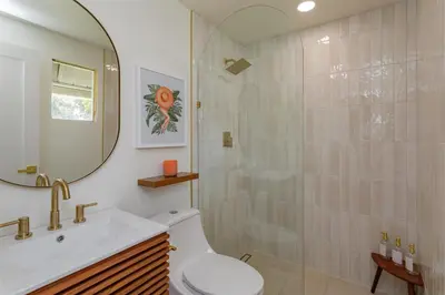 a bathroom with a shower and a toilet and a sink at Orlando Home 6430: Purpose-Driven A-Frame Vacation Home in Clermont