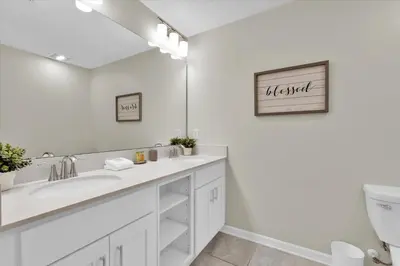 a white bathroom with a sink and a toilet at Book Now: Orlando Condo 6439 at Storey Lake Resort in Kissimmee