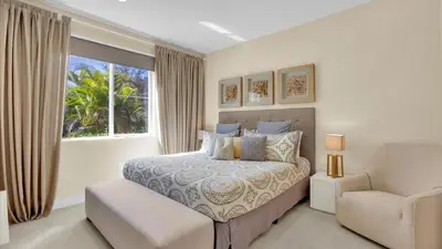 a bedroom with a bed and a chair and a window at Book Now: Orlando Townhome 6440 Near Disney Magic in Orlando