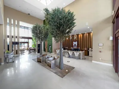a lobby with two trees in the middle of a building at Book Now: Orlando Townhome 6440 Near Disney Magic in Orlando