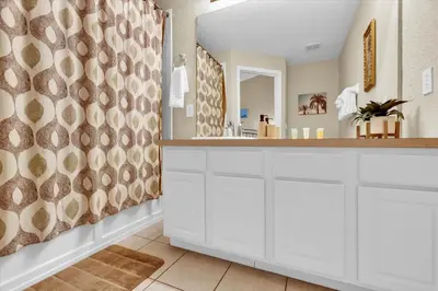 a bathroom with white cabinets and a large mirror at Orlando Townhome 6442 - Private Pool Club Access in Orlando