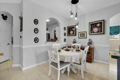 a dining room with a white table and chairs at Orlando Condo 6445: Family Fun Near Disney in Kissimmee