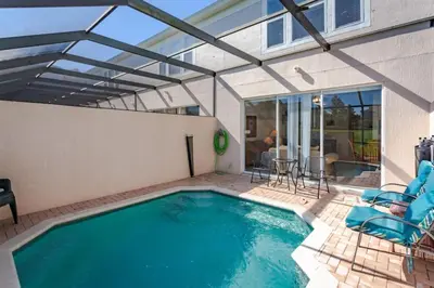 a swimming pool with a glass roof at 5-Star Orlando Townhome 6446: Family Fun Awaits in Kissimmee