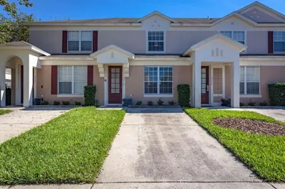 a house with a driveway in front of it at 5-Star Orlando Townhome 6446: Family Fun Awaits in Kissimmee