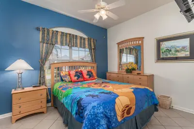 a bedroom with a bed and a ceiling fan at Orlando Villa 6449: Experience Magic and Relaxation in Kissimmee