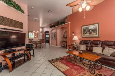 a living room with a couch and a tv at Orlando Villa 6449: Experience Magic and Relaxation in Kissimmee