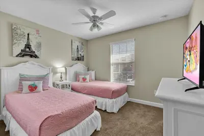 a bedroom with two beds and a ceiling fan at 5-Star Orlando Villa 6452: Family Fun Resort Access in Kissimmee
