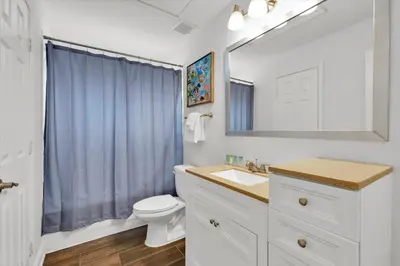 a bathroom with a sink and a toilet and a mirror at Orlando Villa 6469: 6BR Home Near Disney Parks in Kissimmee