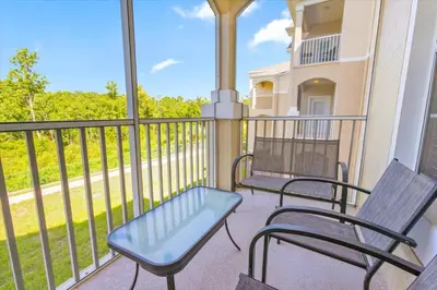 a balcony with two chairs and a bench on it at Orlando Condo 6470 - 3BR Family Getaway in Kissimmee