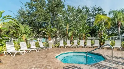 a group of chairs and a swimming pool at Orlando Condo 6470 - 3BR Family Getaway in Kissimmee