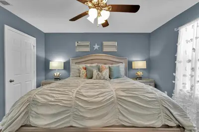 a bedroom with a large bed with blue walls at Orlando Villa 6472 - Family Getaway Home in Orlando