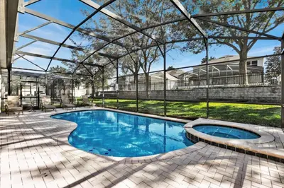 a swimming pool with a pergola next to a house at Orlando Villa 6472 - Family Getaway Home in Orlando