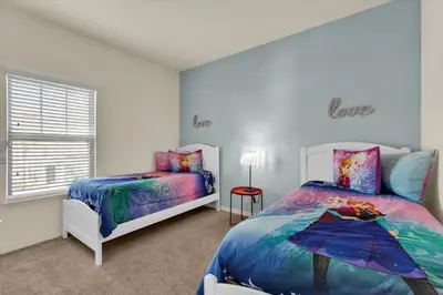 a bedroom with two beds and a window at Orlando Townhome 6458: Perfect Base for Your Disney Trip in Kissimmee