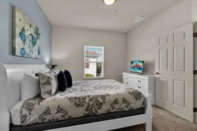 a bedroom with a white bed and a window at Orlando Townhome 6458: Perfect Base for Your Disney Trip in Kissimmee