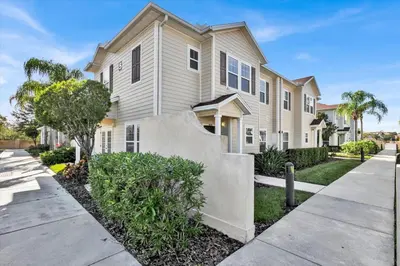 a house with a sidewalk in front of it at Orlando Townhome 6458: Perfect Base for Your Disney Trip in Kissimmee