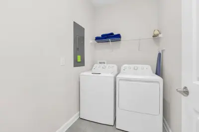 two washing machines in a white laundry room at You and Your Family will Love this Luxury Villa on Storey Lake Resort Orlando Villa 6295 in Kissimmee