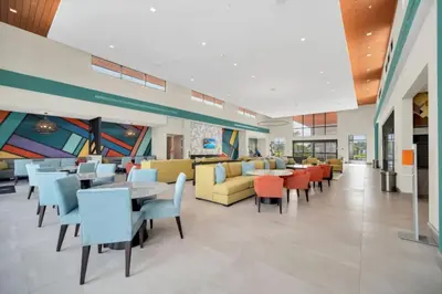 a cafeteria with tables and chairs in a building at Orlando Villa 6401 - Dream Stay at Paradiso Resort in Orlando
