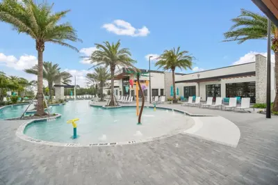 a swimming pool with palm trees and a building at Orlando Villa 6401 - Dream Stay at Paradiso Resort in Orlando