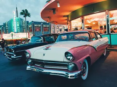 two old cars parked in front of a store at Picture Renting Your Own Luxury Villa on the Exclusive Paradiso Grande Resort close to Disney Orlando Villa 6402 in Orlando