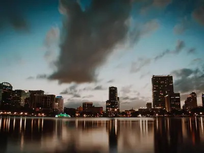 a view of a city skyline at night at The Secret to Enjoying the Best Orlando Villa Holiday while Staying on Paradiso Grande Resort Orlando Villa 6409 in Orlando