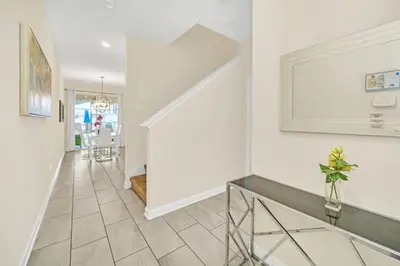 a hallway with white walls and a staircase with a vase at Rent Orlando Villa 6235: Perfect Luxury Villa by Disney in Kissimmee