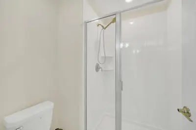 a bathroom with a shower with a glass door at Rent Orlando Villa 6235: Perfect Luxury Villa by Disney in Kissimmee
