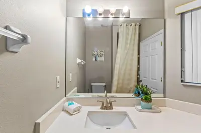 a bathroom with a sink and a large mirror at Orlando Villa 6244: Luxury 5-Star Villa Minutes from Disney in Kissimmee