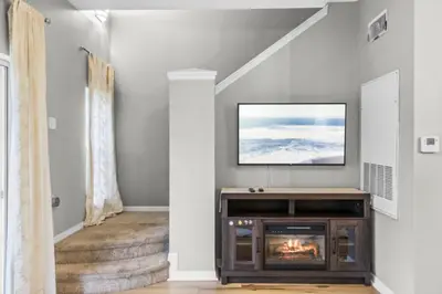 a living room with a tv and a fireplace at Orlando Villa 6244: Luxury 5-Star Villa Minutes from Disney in Kissimmee