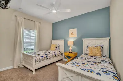 a bedroom with two beds and a window at Orlando Villa 6243: The Best Orlando Getaway at Storey Lake in Kissimmee