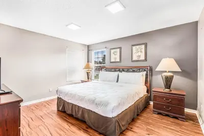 a bedroom with a large bed and a window at Orlando Villa 6245: Dream Holiday Villa in Emerald Island in Kissimmee
