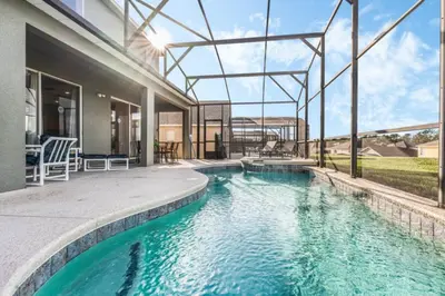 a swimming pool in the backyard of a house at Orlando Villa 6245: Dream Holiday Villa in Emerald Island in Kissimmee