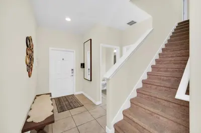 a white staircase in a house with a white door at Orlando Villa 6256: Experience 5-Star Luxury at Paradise Palms Resort in Kissimmee