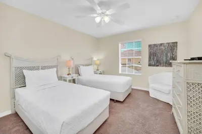 a white bedroom with two beds and a window at Orlando Villa 6256: Experience 5-Star Luxury at Paradise Palms Resort in Kissimmee