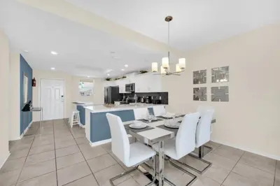 a kitchen and dining room with a table and chairs at Orlando Condo 6259: Ultimate Family Retreat on Storey Lake in Kissimmee
