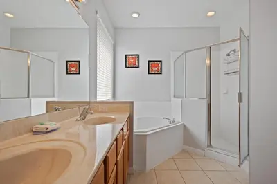 a bathroom with a tub and a sink and a shower at Luxury Villa with private Pool Emerald Island Resort Orlando Villa 5074 in Kissimmee