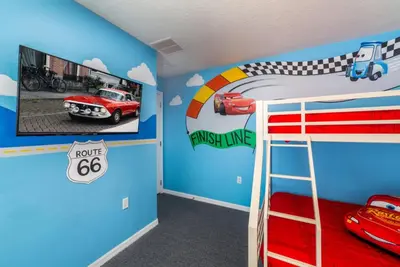 a room with a bunk bed with a fire truck and a race car mural at 5 Star Mansion with Private Pool on Formosa Gardens Orlando Manion 5075 in Orlando