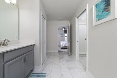 a white bathroom with a sink and a mirror at The Ultimate Mansion with Private Pool on Storey Lake Resort Orlando Mansion 5287 in Kissimmee