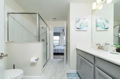 a bathroom with a shower and a toilet and a sink at The Ultimate Mansion with Private Pool on Storey Lake Resort Orlando Mansion 5287 in Kissimmee