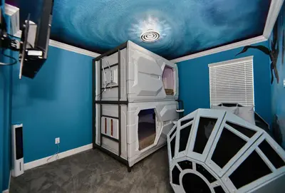 a bedroom with a blue walls and a room with a bed at 5 Star Mansion with Private Pool on Veranda Palms Orlando Mansion 5377 in Kissimmee