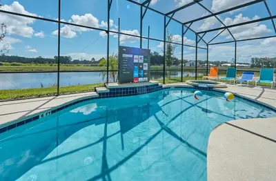 a large swimming pool with a view of the water at 5 Star Mansion with Private Pool on Veranda Palms Orlando Mansion 5377 in Kissimmee
