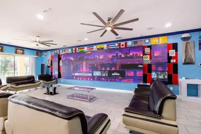 a waiting room with couches and a wall with a mural at Exclusive Mansion with Large Private Pool on Veranda Palms Orlando Mansion 5378 in Kissimmee