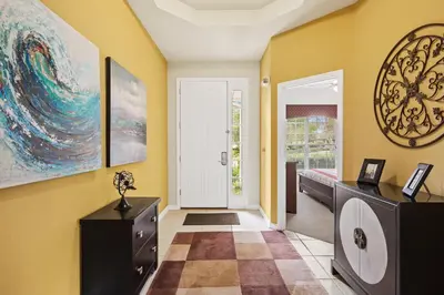 a hallway with yellow walls and a door with a painting at Luxury Villa with Pool on Windsor Hills Resort Orlando Villa 5390 in Orlando