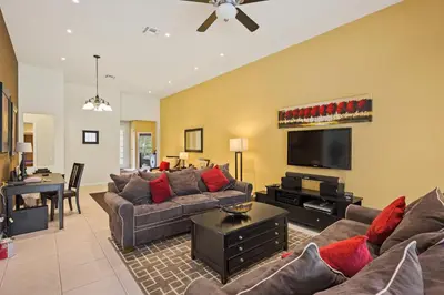 a living room with a couch and a flat screen tv at Luxury Villa with Pool on Windsor Hills Resort Orlando Villa 5390 in Orlando