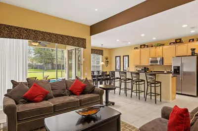 a living room with a couch and a kitchen at Luxury Villa with Pool on Windsor Hills Resort Orlando Villa 5390 in Orlando