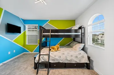a bedroom with a bunk bed with a brown dog laying on the bed at Beautiful Mansion with first class amenities on Solara Resort Orlando Mansion 5715 in Orlando