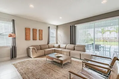 a living room with a couch and a table at Rent the Perfect 5 Bedroom Villa Encore Resort Villa 6416 in Orlando