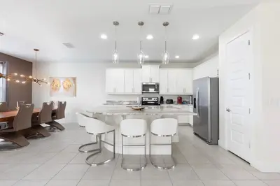 a kitchen and dining room with a table and chairs at Rent the Perfect 5 Bedroom Villa Encore Resort Villa 6416 in Orlando