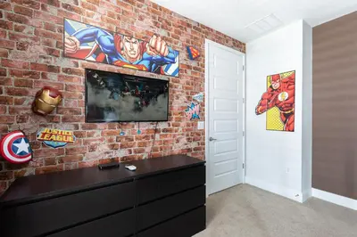 a room with a brick wall with a tv on it at Rent the Perfect 5 Bedroom Villa Encore Resort Villa 6416 in Orlando
