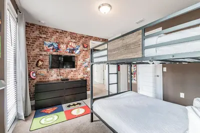 a bedroom with a bunk bed and a brick wall at Rent the Perfect 5 Bedroom Villa Encore Resort Villa 6416 in Orlando